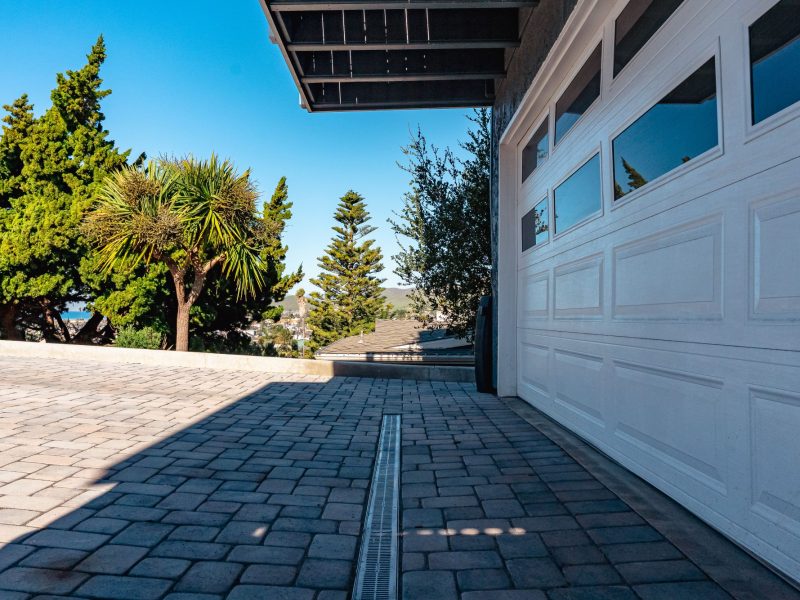 Linear drainage channel installed within a sloped paver driveway in Morro Bay, California.