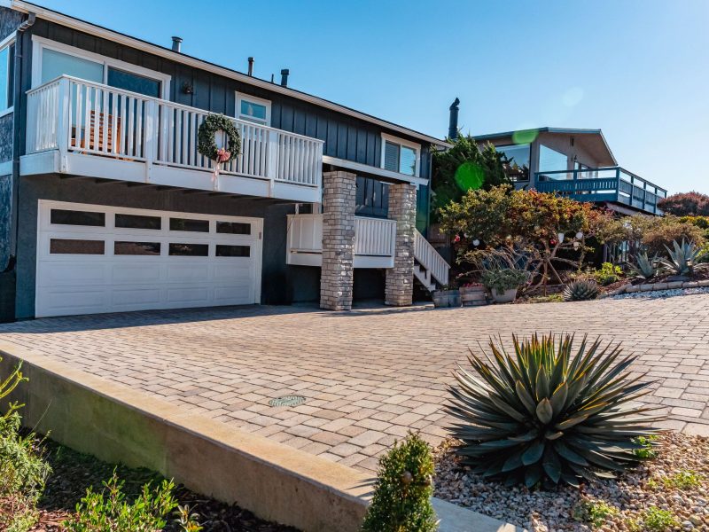 Concrete curb and edge detail alongside a custom paver driveway installation in Morro Bay.
