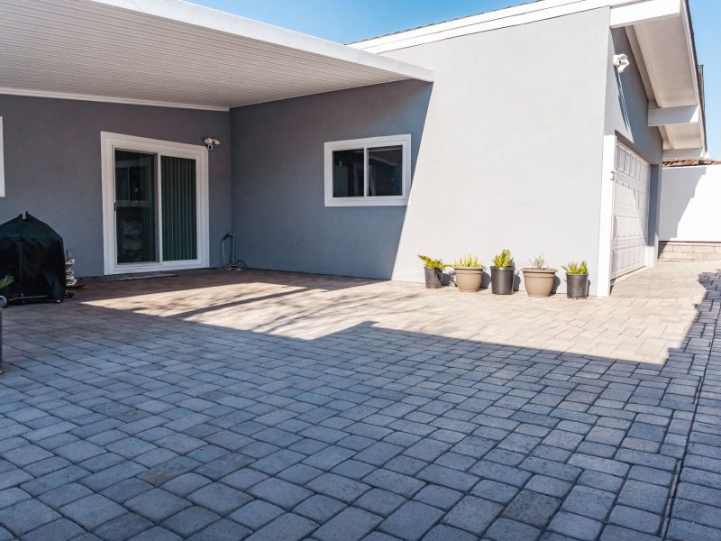 Concrete paver patio and driveway extension installed in a Morro Bay coastal home backyard.