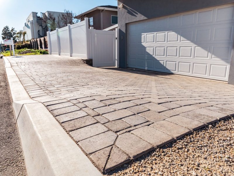 Wide street view of a custom paver driveway installation enhancing curb appeal in Morro Bay, California.