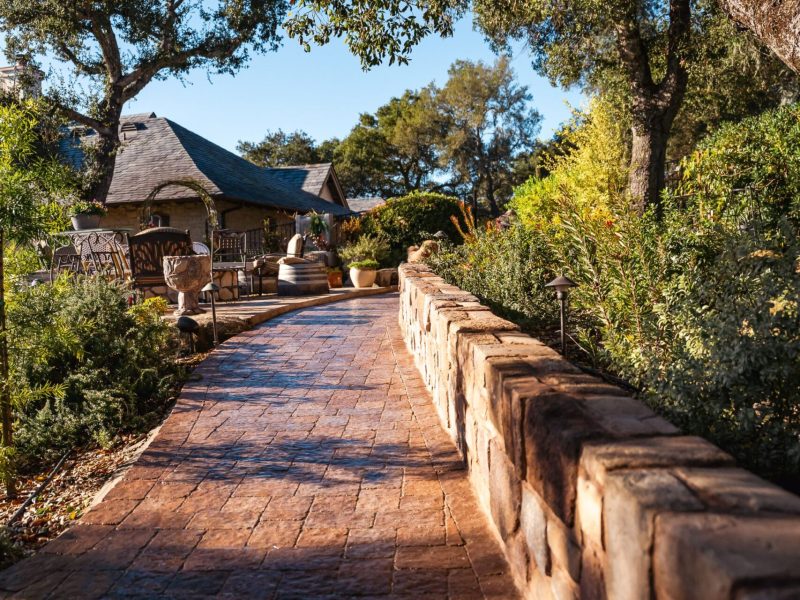 Custom hardscape walkway project in Paso Robles featuring stamped concrete pavers and elevated patio access.