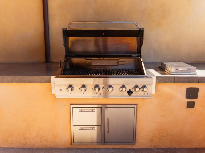 Close-up of custom BBQ island grill with stainless steel finish in a San Luis Obispo outdoor kitchen.