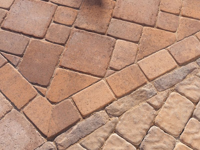Detailed view of interlocking paver pool deck pattern installed during a San Luis Obispo pool transformation project.