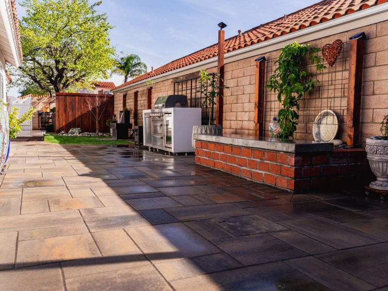 Built-in outdoor kitchen with grill and storage installed on a custom paver patio in Santa Maria.