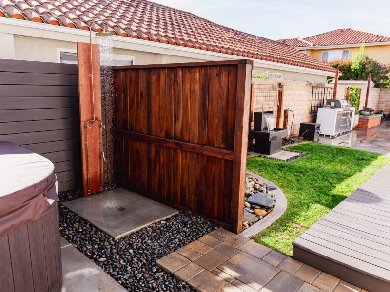 Wood privacy wall with outdoor shower adjacent to landscaped side yard in Santa Maria.