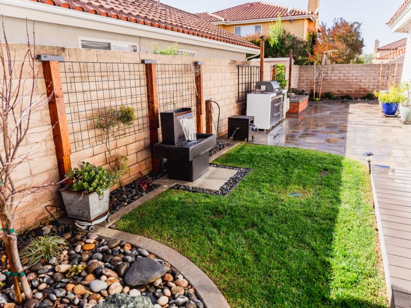 Complete side yard landscape renovation in Santa Maria featuring paver patio, lawn, water features, and outdoor kitchen.