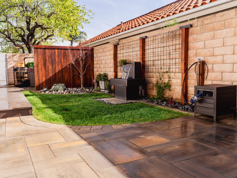 Custom paver patio and curved lawn layout in a Santa Maria side yard landscape renovation.